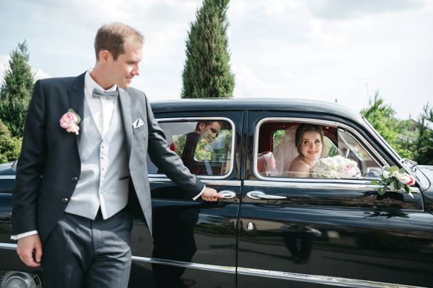 bridegroom-is-standing-by-car-while-bride-is-car_8353-9496