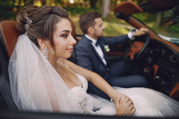 young-beautiful-bride-is-sitting-car-with-her-husband_1157-13359